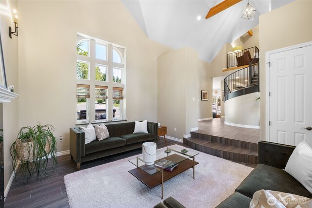 living area with dark wood-style floors, baseboards, stairs, and high vaulted ceiling