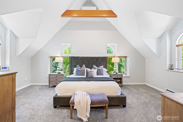 bedroom with a baseboard heating unit, light colored carpet, vaulted ceiling with beams, and baseboards