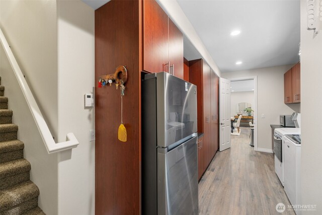 kitchen with freestanding refrigerator, white electric stove, light wood-style flooring, and recessed lighting