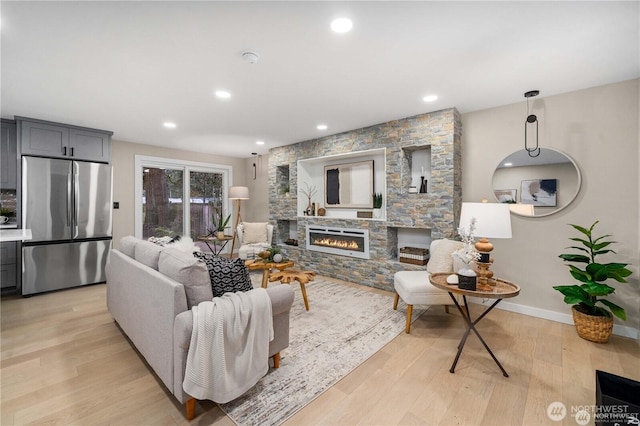 living room featuring light hardwood / wood-style floors and a fireplace