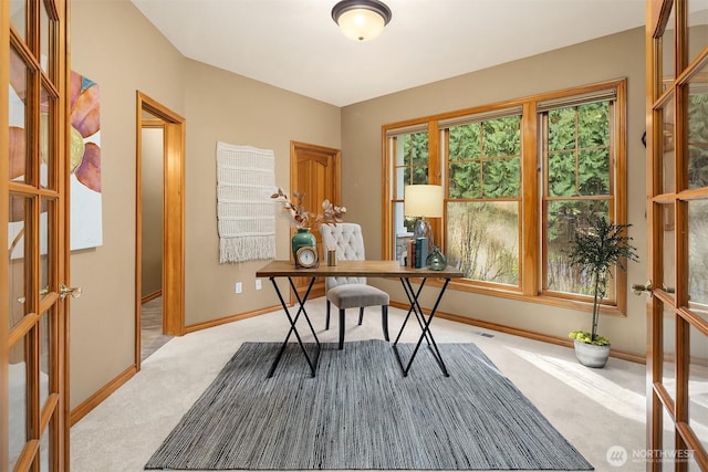 office space with carpet, baseboards, and french doors