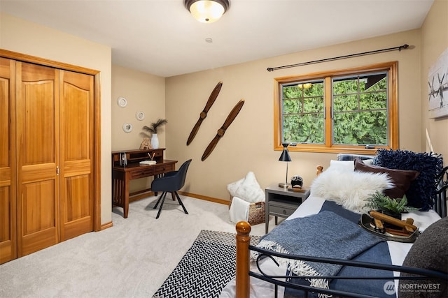 office featuring baseboards and light colored carpet