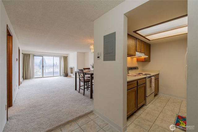 kitchen with brown cabinets, white range with electric cooktop, open floor plan, light carpet, and electric panel