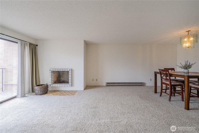 living area with carpet floors, a brick fireplace, baseboard heating, and a textured ceiling