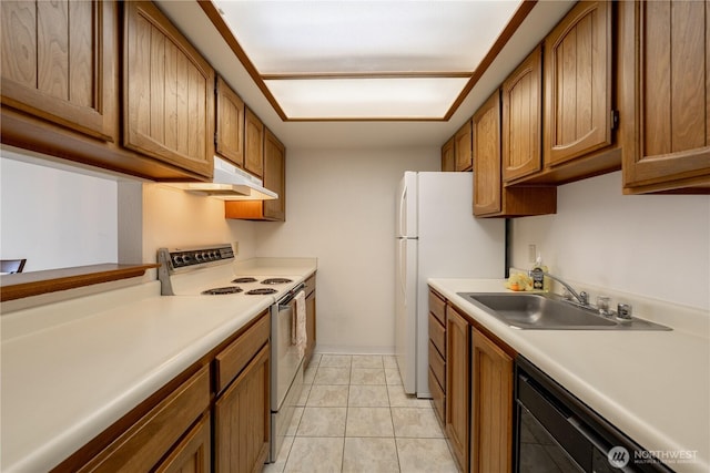 kitchen with under cabinet range hood, white appliances, a sink, light countertops, and brown cabinets