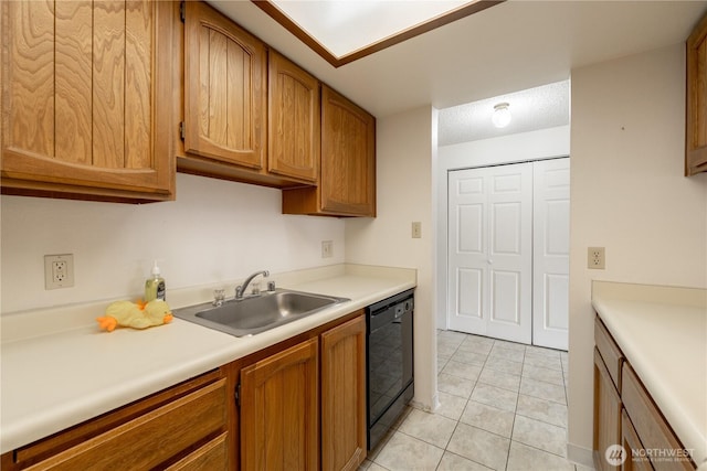 kitchen featuring light tile patterned flooring, a sink, light countertops, brown cabinets, and dishwasher