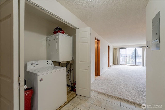 clothes washing area featuring stacked washer / drying machine, light colored carpet, a textured ceiling, laundry area, and electric panel