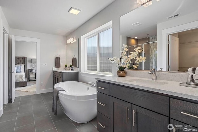 bathroom featuring vanity, tile patterned flooring, and independent shower and bath