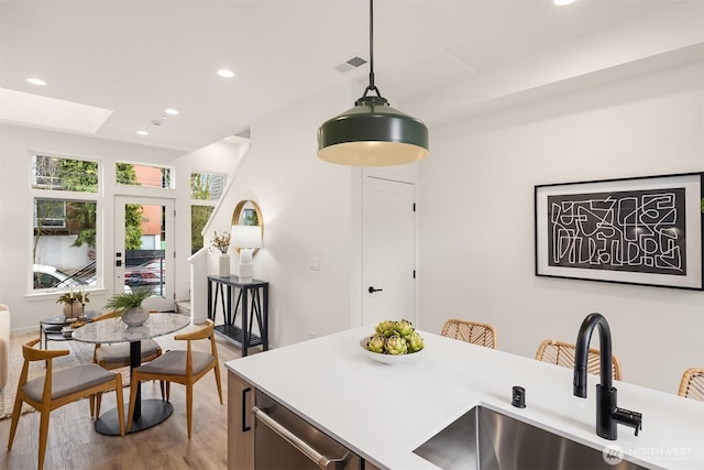 dining room featuring visible vents, recessed lighting, a skylight, and wood finished floors