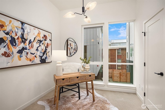 home office featuring a notable chandelier, baseboards, and carpet floors