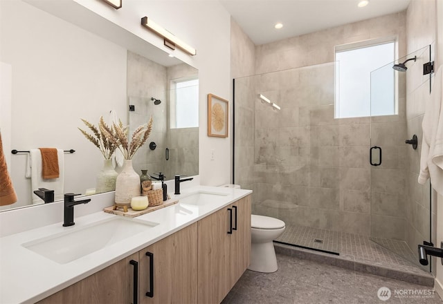 full bath with a stall shower, a wealth of natural light, and a sink