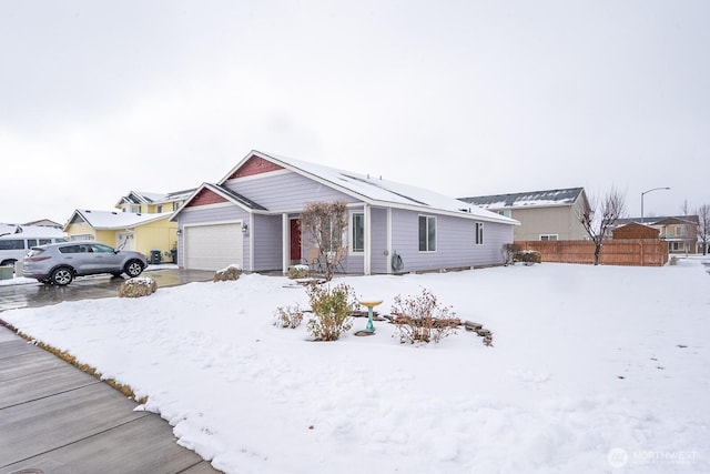 single story home with a garage and fence