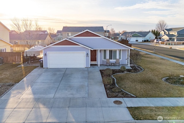 view of front of house with an attached garage, fence, a residential view, a porch, and driveway