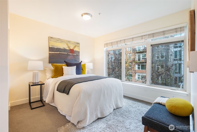 carpeted bedroom featuring baseboards