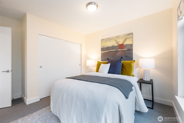 bedroom with light carpet, baseboards, and a closet