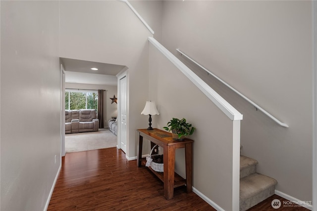 stairs featuring wood finished floors and baseboards