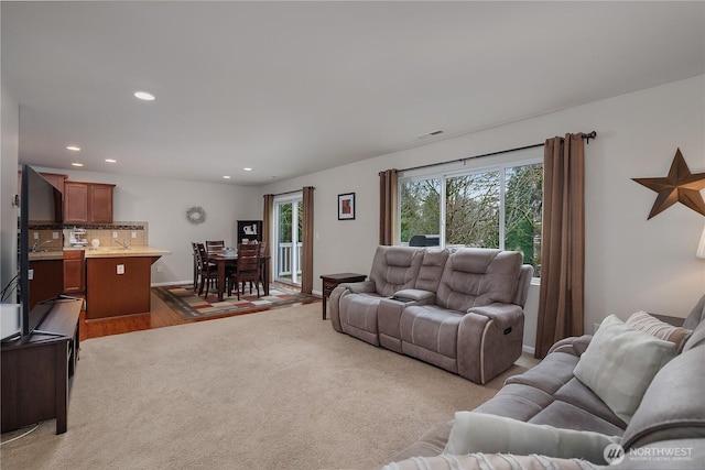 living area featuring visible vents, baseboards, wood finished floors, carpet flooring, and recessed lighting