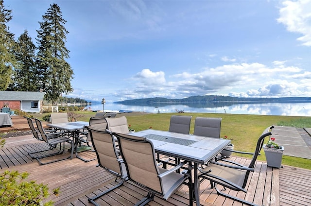 wooden deck featuring a yard and a water view