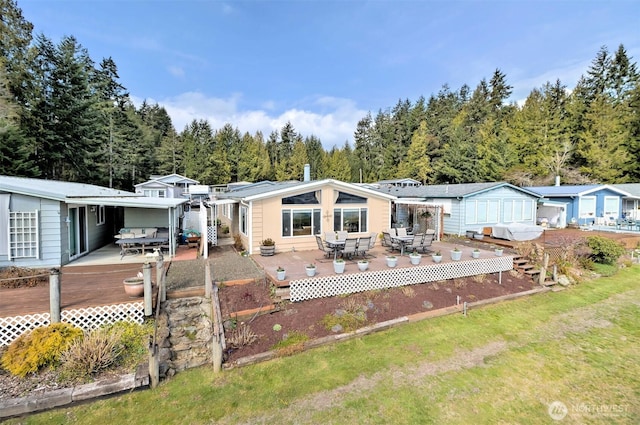 back of house with a yard and a wooden deck