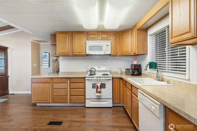 kitchen featuring dark hardwood / wood-style flooring, sink, and white appliances