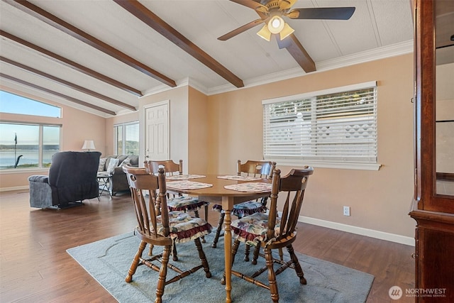 dining space with ceiling fan, a water view, vaulted ceiling with beams, and dark hardwood / wood-style flooring