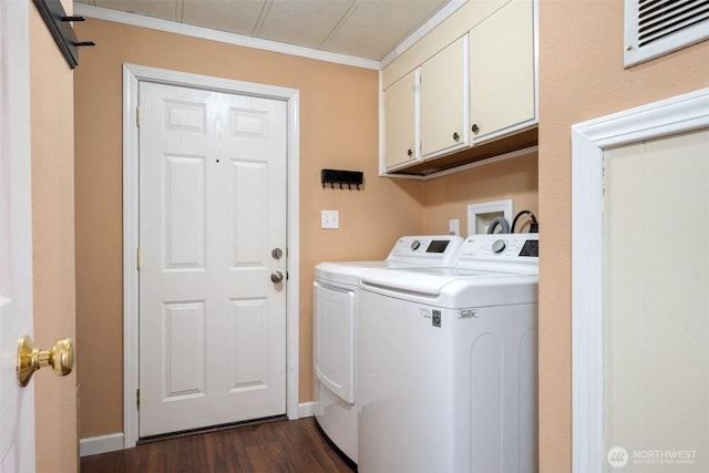 clothes washing area with cabinets, ornamental molding, dark hardwood / wood-style floors, and independent washer and dryer