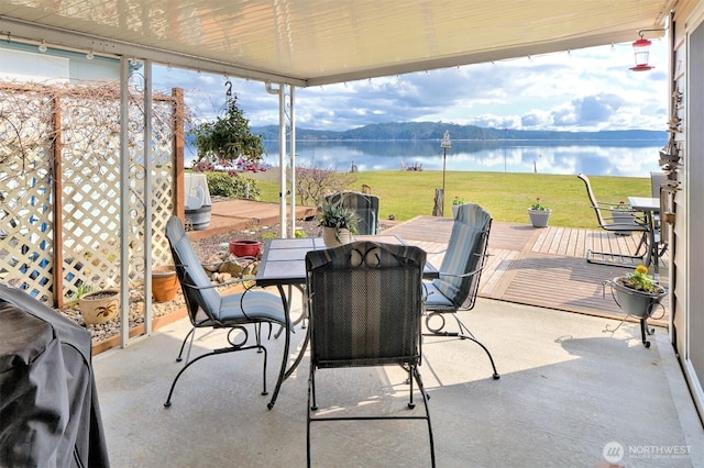 view of patio with a water and mountain view