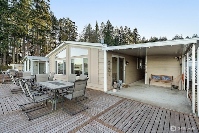 wooden terrace with an outbuilding