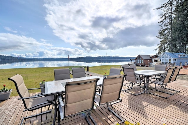 wooden deck with a lawn and a water view