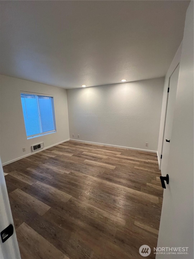 empty room with dark wood-type flooring