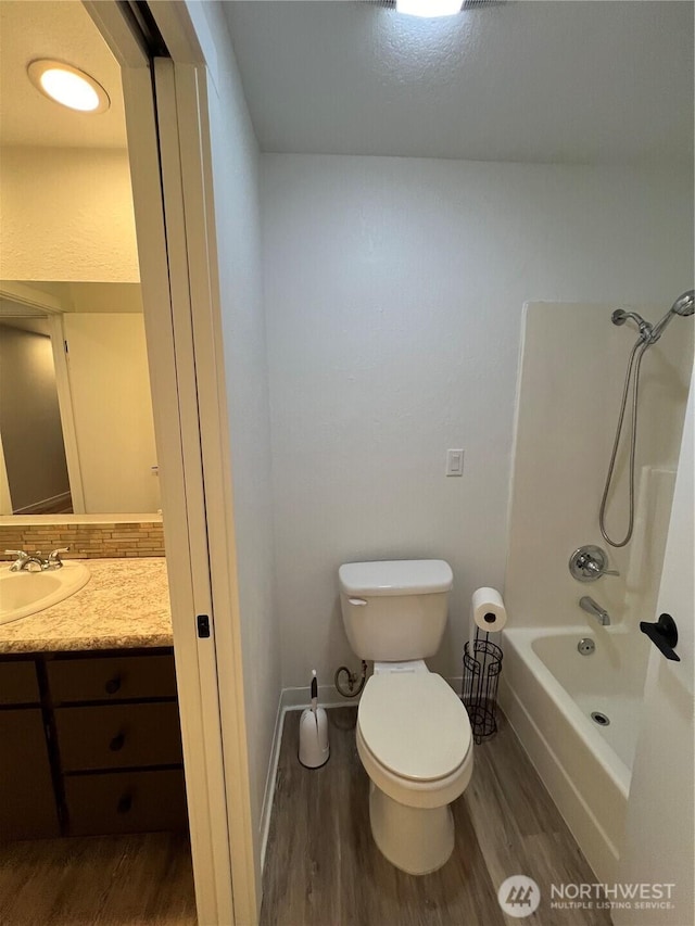 full bathroom featuring shower / bathing tub combination, vanity, toilet, and hardwood / wood-style floors