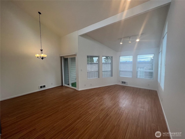 spare room with rail lighting, high vaulted ceiling, and hardwood / wood-style floors