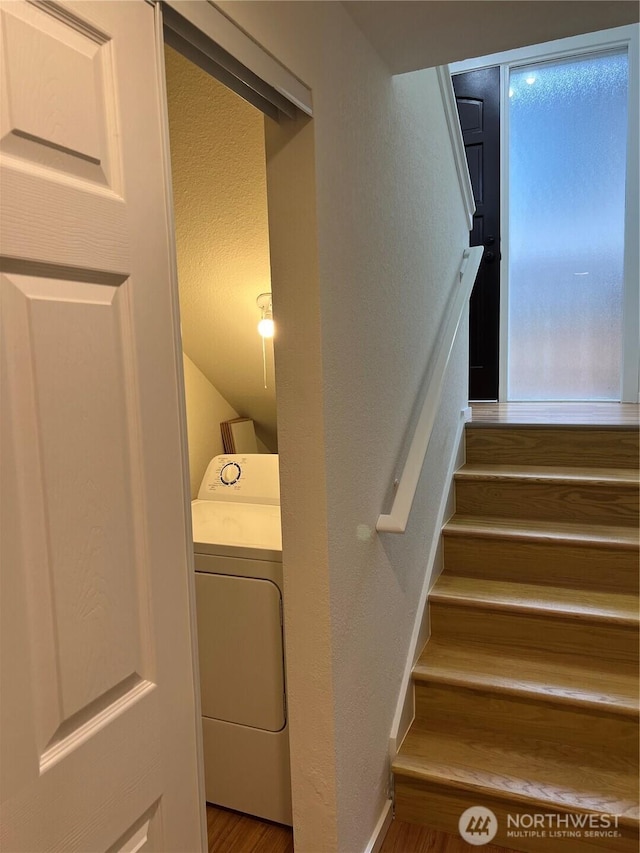 stairway with washer / dryer and wood-type flooring