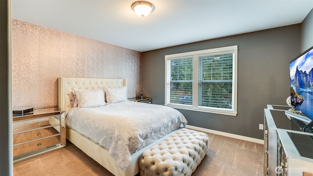 carpeted bedroom featuring baseboards