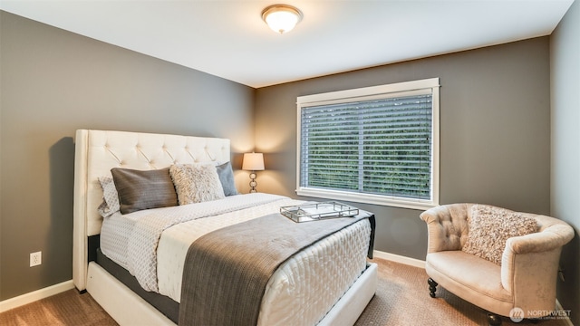 bedroom with carpet and baseboards