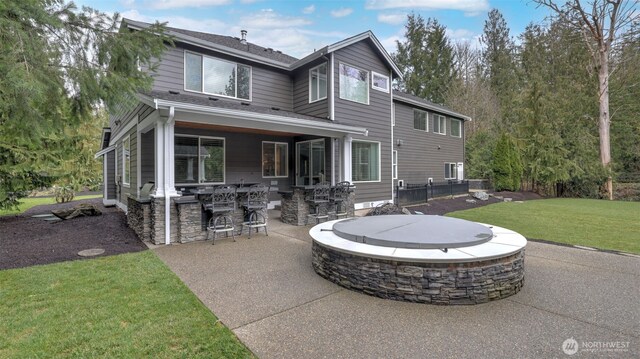 view of front of home with a fire pit, a patio area, and a front yard