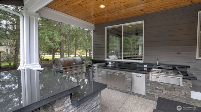 view of patio with an outdoor kitchen and area for grilling