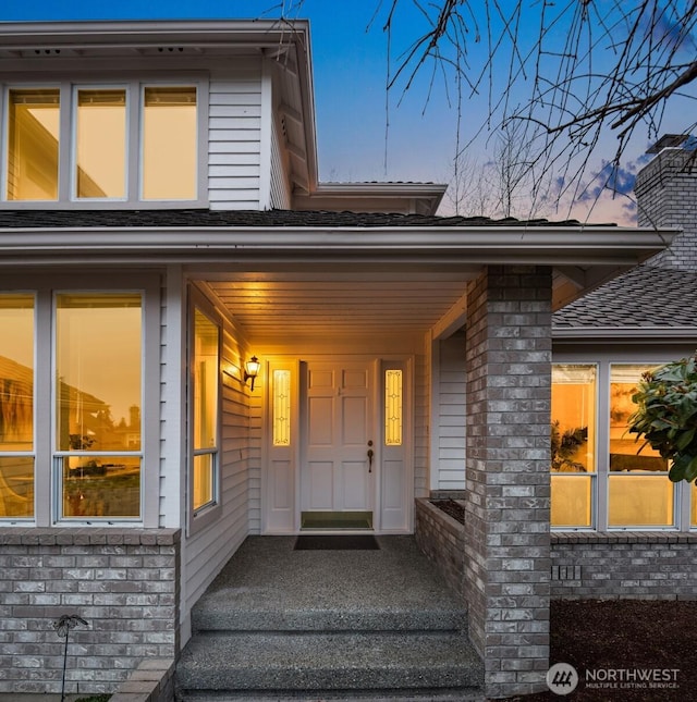 exterior entry at dusk with a chimney