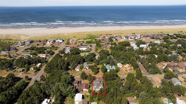 aerial view with a beach view, a water view, and a residential view