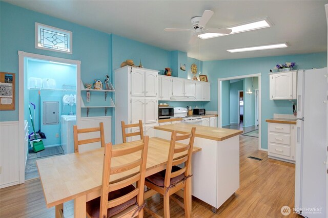 kitchen featuring white appliances, light wood-style floors, white cabinets, and light countertops