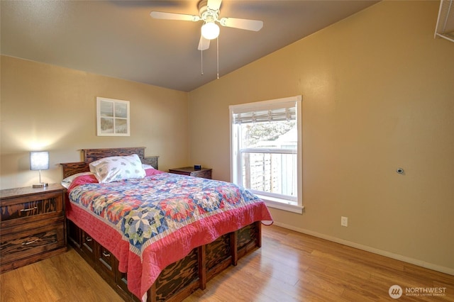 bedroom featuring light wood-style floors, lofted ceiling, ceiling fan, and baseboards