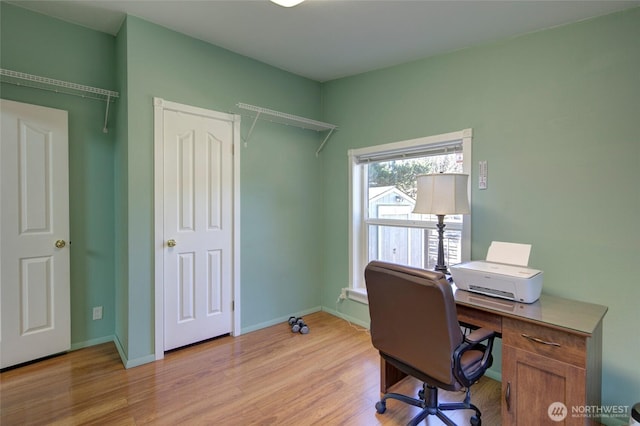 office area featuring light wood-style floors and baseboards