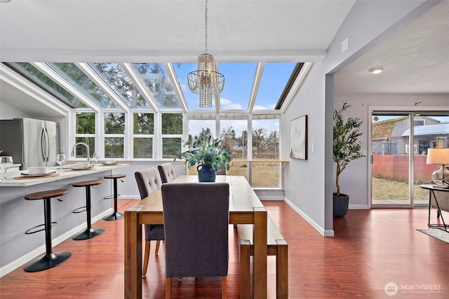 dining space featuring dark hardwood / wood-style flooring and a notable chandelier