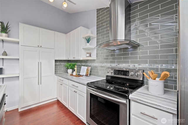 kitchen with white cabinetry, backsplash, stainless steel electric range oven, and wall chimney range hood