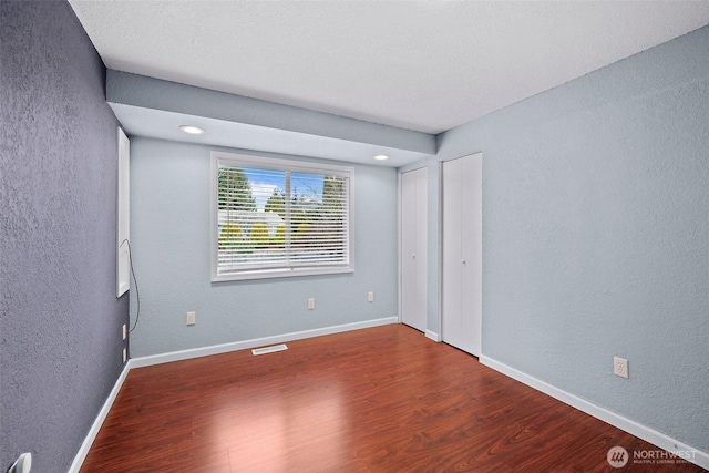 unfurnished bedroom featuring hardwood / wood-style flooring