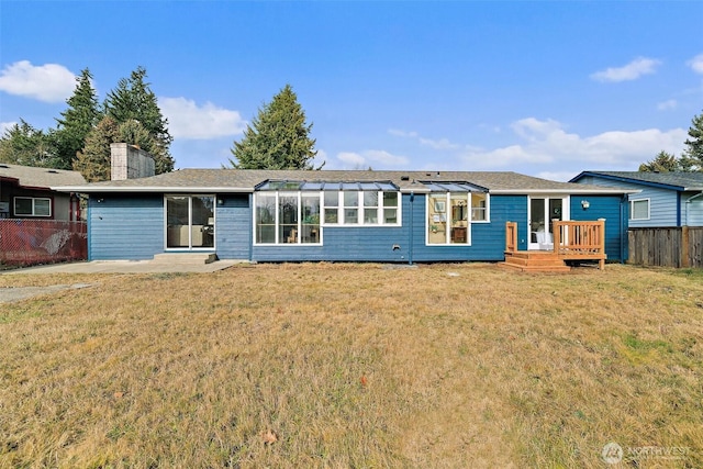 view of front of home with a deck and a front yard