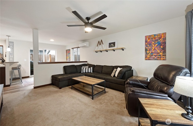 carpeted living room with a wall unit AC and ceiling fan