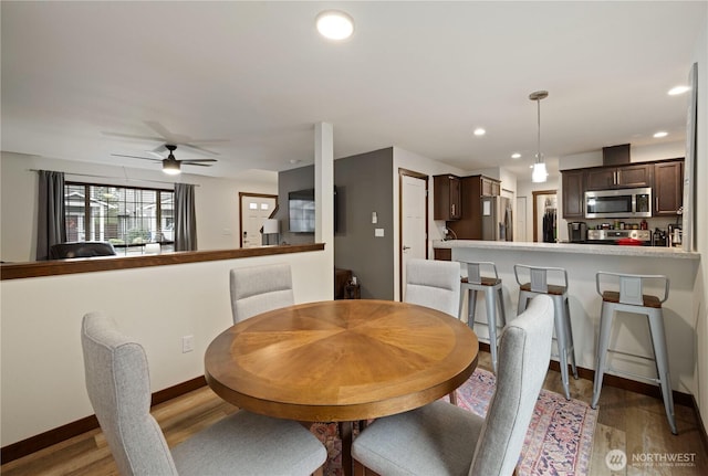 dining area featuring ceiling fan and wood-type flooring