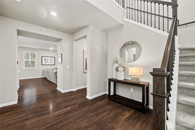 foyer featuring stairs, recessed lighting, dark wood finished floors, and baseboards