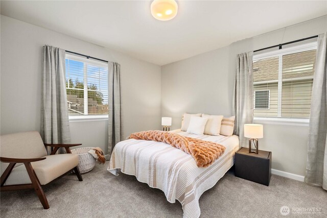 carpeted bedroom featuring baseboards